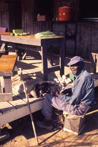 Pop Jackson in Jonestown, c. 1976-77. Text on slide mount: Me - cleaning vegetables