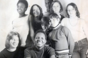 Black-and-white photo of a group of smiling children and teenagers of diverse backgrounds gathered for a portrait in Redwood Valley.